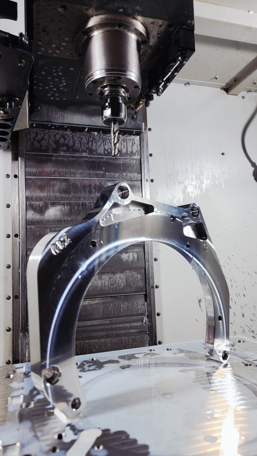 RBZ Harmony billet aluminum adapter plate during final machining pass under Haas spindle with visible cutting tool detail