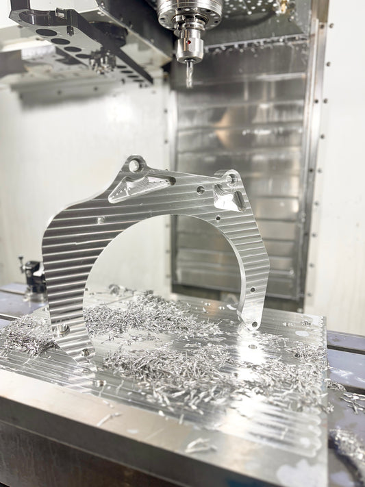 RBZ Harmony billet aluminum adapter plate during final machining pass under Haas spindle with visible cutting tool detail