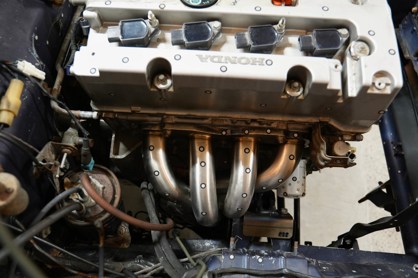 RBZ Harmony K24 engine mount installed on Honda K-series block in Suzuki Samurai swap with Cerakote finish visible