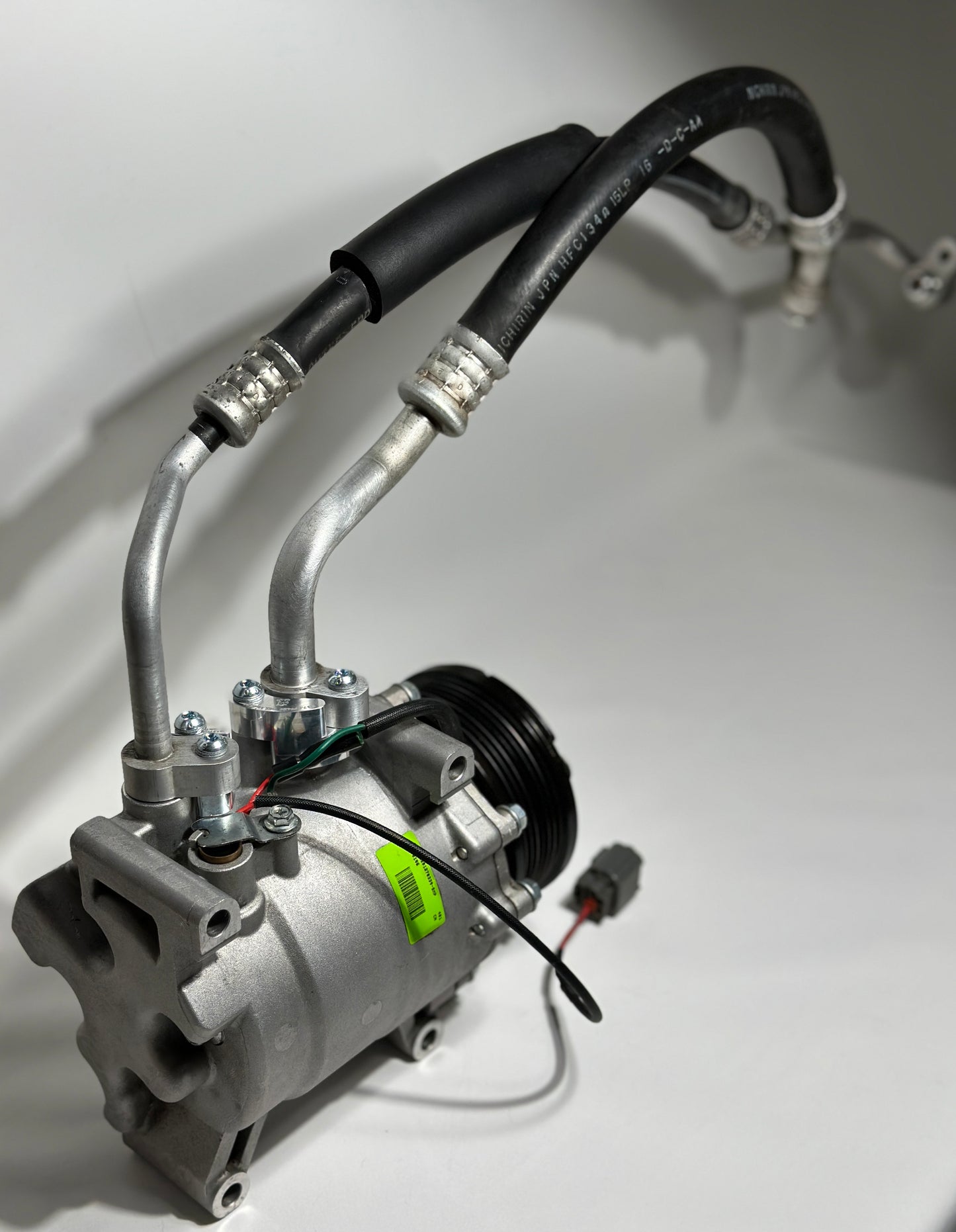 RBZ Harmony billet aluminum adapter holding OEM Honda S2000 AC line for K-series compressor clearance