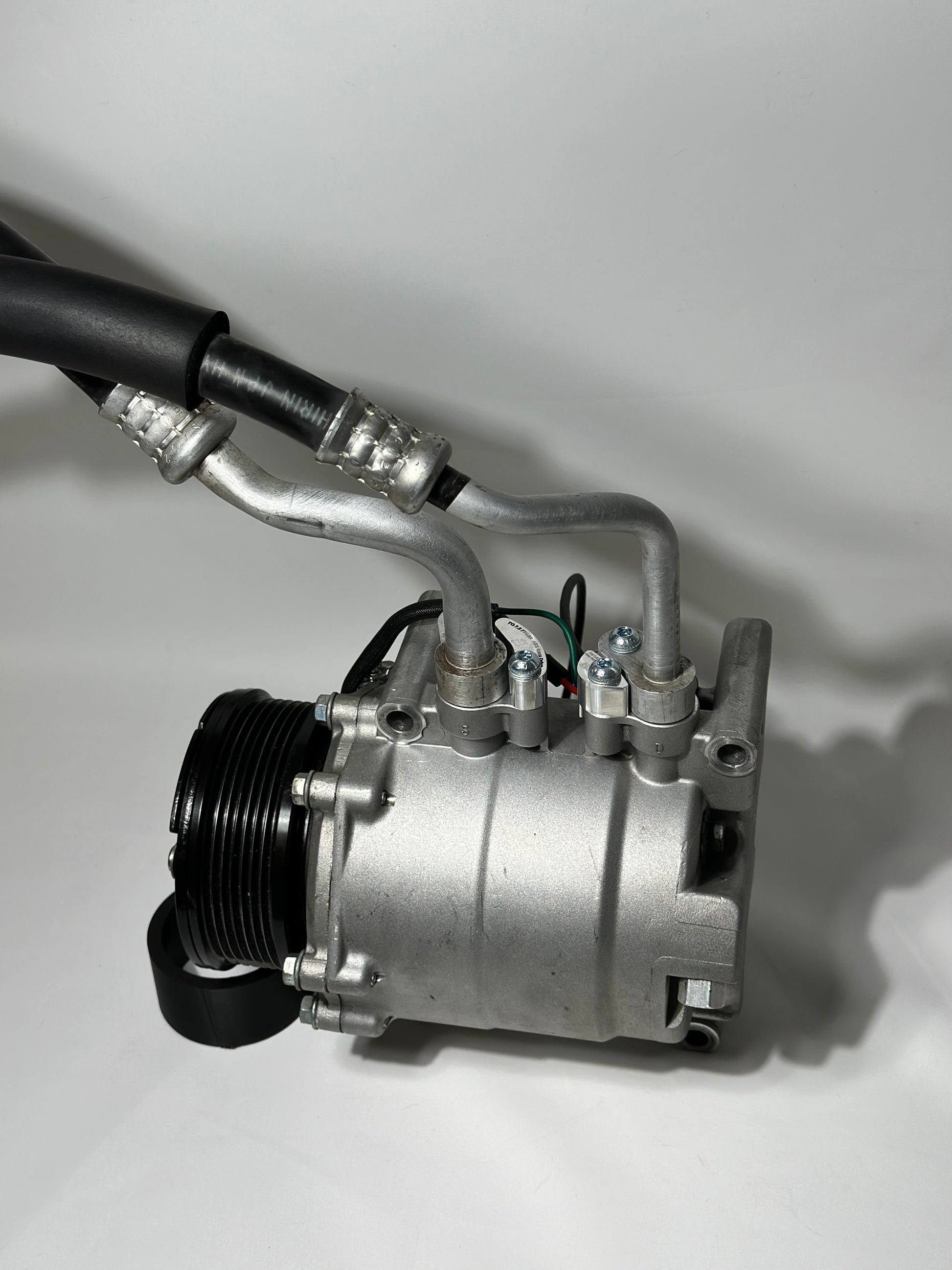 RBZ Harmony billet aluminum adapters holding OEM Honda S2000 AC line for K-series compressor clearance